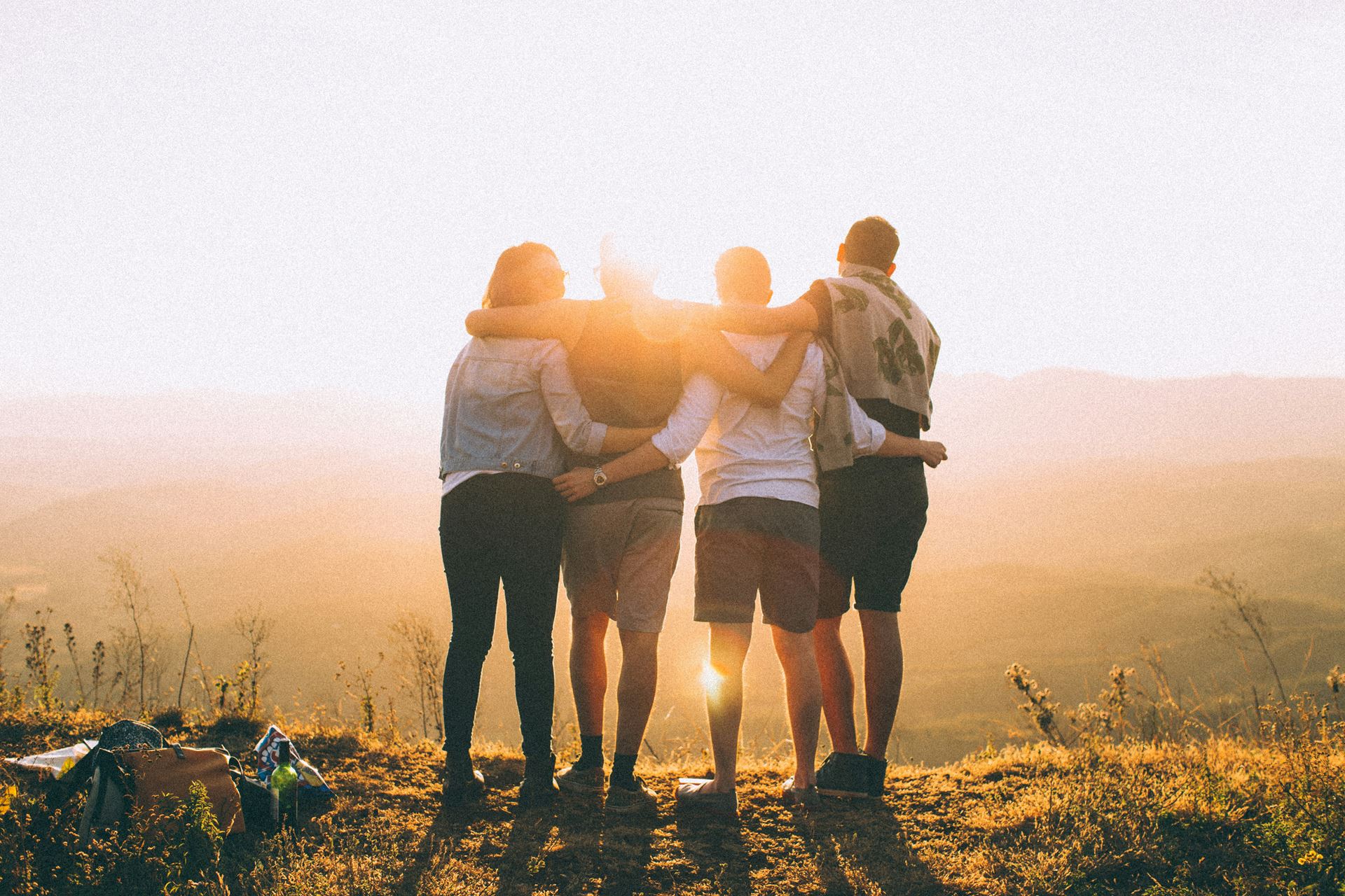 Group of people in front of a sunset